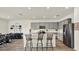 Open concept kitchen with light gray cabinets, stainless steel appliances, and a large center island with seating at 3952 Almond Brook Blvd, Land O Lakes, FL 34638