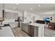 Bright kitchen with gray cabinets, stainless steel appliances, a large island and open to the living room at 3952 Almond Brook Blvd, Land O Lakes, FL 34638