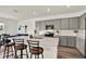 Modern kitchen with light gray cabinets, quartz countertops, stainless appliances, and eat-in island at 3952 Almond Brook Blvd, Land O Lakes, FL 34638