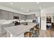 Bright kitchen features gray cabinets, stainless steel appliances, large island with seating and plenty of counter space at 3952 Almond Brook Blvd, Land O Lakes, FL 34638