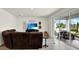 Living room with sliding glass doors to the backyard patio, grill and backyard furniture at 3952 Almond Brook Blvd, Land O Lakes, FL 34638