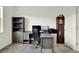 Office space with gray wooden desk, printer, grandfather clock, and natural light at 3952 Almond Brook Blvd, Land O Lakes, FL 34638