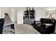Well-lit carpeted office area featuring gray shelving, a dark chair, and a sleek modern desk at 3952 Almond Brook Blvd, Land O Lakes, FL 34638
