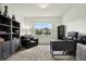 Comfortable carpeted office with a black leather chair, gray desk, and neutral color palette at 3952 Almond Brook Blvd, Land O Lakes, FL 34638