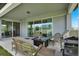Covered patio features comfortable wicker seating and a stainless steel BBQ grill at 3952 Almond Brook Blvd, Land O Lakes, FL 34638