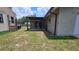 View of backyard with covered patio and shed at 39772 Meadowood Loop, Zephyrhills, FL 33542