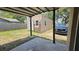 View from the covered patio looking at the shed and car at 39772 Meadowood Loop, Zephyrhills, FL 33542