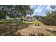 Spacious backyard with a shed, partially fenced with green grass and plenty of room for outdoor activities at 39772 Meadowood Loop, Zephyrhills, FL 33542