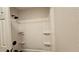 Bathroom featuring a white tub and shower with built-in shelves at 39772 Meadowood Loop, Zephyrhills, FL 33542