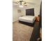 Bedroom featuring a bed with neutral carpet and dark curtains at 39772 Meadowood Loop, Zephyrhills, FL 33542