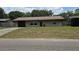 Charming single-story home with a well-maintained lawn and attached garage at 39772 Meadowood Loop, Zephyrhills, FL 33542