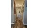 Inviting hallway with wood floors and decorative accents at 39772 Meadowood Loop, Zephyrhills, FL 33542