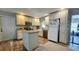 Bright kitchen with an island, farmhouse sink, stainless appliances, and ample cabinet space at 39772 Meadowood Loop, Zephyrhills, FL 33542