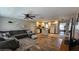 Open-concept living room and kitchen with modern finishes and wood-look floors at 39772 Meadowood Loop, Zephyrhills, FL 33542