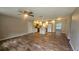 Spacious living room and kitchen area with hard wood floors and modern appliances at 39772 Meadowood Loop, Zephyrhills, FL 33542