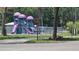 A colorful playground with slides and climbing structures surrounded by trees and green space for outdoor fun at 39772 Meadowood Loop, Zephyrhills, FL 33542