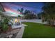 Backyard featuring a green lawn, patio with outdoor seating, and a privacy fence at 4709 W Fair Oaks Ave, Tampa, FL 33611