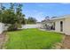 This expansive, fenced backyard features a well-maintained lawn and patio with an outdoor dining set at 4709 W Fair Oaks Ave, Tampa, FL 33611