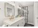 Updated bathroom features double sinks, modern fixtures, and a glass enclosed shower at 4709 W Fair Oaks Ave, Tampa, FL 33611
