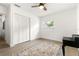 Cozy bedroom featuring a ceiling fan, closet, and neutral walls with wood-look floors at 4709 W Fair Oaks Ave, Tampa, FL 33611
