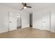Bright bedroom featuring light floors, ceiling fan, and ensuite bathroom with updated fixtures at 4709 W Fair Oaks Ave, Tampa, FL 33611