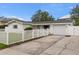 Charming single-story home featuring a long driveway and a classic white picket fence at 4709 W Fair Oaks Ave, Tampa, FL 33611