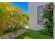 Charming backyard features artificial turf, lush tropical plants, and a glimpse of the sparkling pool at 500 38Th Ne Ave, St Petersburg, FL 33704