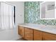 Stylish bathroom featuring double sinks, modern vanity, beautiful wall paper, and decorative mirror at 500 38Th Ne Ave, St Petersburg, FL 33704