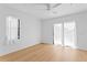 Bright bedroom with hardwood floors, neutral walls, ceiling fan, and two windows providing natural light at 500 38Th Ne Ave, St Petersburg, FL 33704
