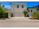 Wide shot of the home's garage with a concrete driveway and landscaping on either side at 500 38Th Ne Ave, St Petersburg, FL 33704