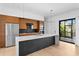 Open kitchen with stainless appliances, center island and access to the outdoors through sliding glass doors at 500 38Th Ne Ave, St Petersburg, FL 33704