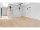 A bright living room featuring a ceiling fan, built-in shelving, and hardwood floors at 500 38Th Ne Ave, St Petersburg, FL 33704