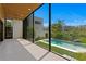 A covered patio overlooks the sparkling pool surrounded by lush greenery, a modern oasis for relaxation and entertainment at 500 38Th Ne Ave, St Petersburg, FL 33704