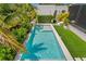 Aerial view of the backyard pool with lush landscaping and artificial turf at 500 38Th Ne Ave, St Petersburg, FL 33704