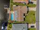 Aerial view of a well-maintained home with a private pool, waterfront access, lush backyard, and boat dock at 5208 Denver Ne St, St Petersburg, FL 33703