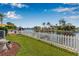 Beautifully landscaped backyard with white picket fence overlooking the water at 5208 Denver Ne St, St Petersburg, FL 33703