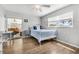 Cozy bedroom with wood floors, a ceiling fan, and a view to an outdoor seating area at 5208 Denver Ne St, St Petersburg, FL 33703