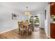 Bright dining room featuring wood floors, modern lighting, and sliding doors to the outdoor living area at 5208 Denver Ne St, St Petersburg, FL 33703