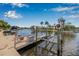 Private boat dock with lift overlooking serene waterfront and beautiful landscaping at 5208 Denver Ne St, St Petersburg, FL 33703