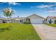 Landscaped front yard with fresh lawn, updated landscaping, and a two-car garage on this property at 5208 Denver Ne St, St Petersburg, FL 33703