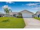 Well-manicured front lawn showcasing a charming single-story home with an attached garage at 5208 Denver Ne St, St Petersburg, FL 33703