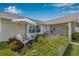 Charming front yard featuring colorful flowers, lush greenery, and seating area with an umbrella at 5208 Denver Ne St, St Petersburg, FL 33703