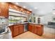 Kitchen with stainless steel dishwasher and wooden cabinets, overlooking the water and outdoor space at 5208 Denver Ne St, St Petersburg, FL 33703