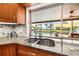 Granite counters at kitchen sink overlook outdoor living area and waterway at 5208 Denver Ne St, St Petersburg, FL 33703