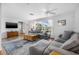 Comfortable living room featuring hardwood floors, a large window, and ample seating for relaxing at 5208 Denver Ne St, St Petersburg, FL 33703