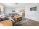 Open-concept living room boasting hardwood floors, a comfortable sofa, and views into the adjacent dining space at 5208 Denver Ne St, St Petersburg, FL 33703