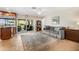 Open-concept living area featuring tile floors, a large rug, comfortable seating, and sliding glass doors to the outdoor space at 5208 Denver Ne St, St Petersburg, FL 33703