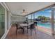Covered patio with outdoor dining and seating area, adjacent to a pool and waterfront, ideal for entertaining at 5208 Denver Ne St, St Petersburg, FL 33703