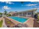 Beautiful pool with brick pavers, a covered lanai, and lush landscaping at 5208 Denver Ne St, St Petersburg, FL 33703