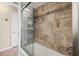 Stylish shower/tub combination with glass doors and tiled surround, offering a clean and modern look at 5208 Denver Ne St, St Petersburg, FL 33703